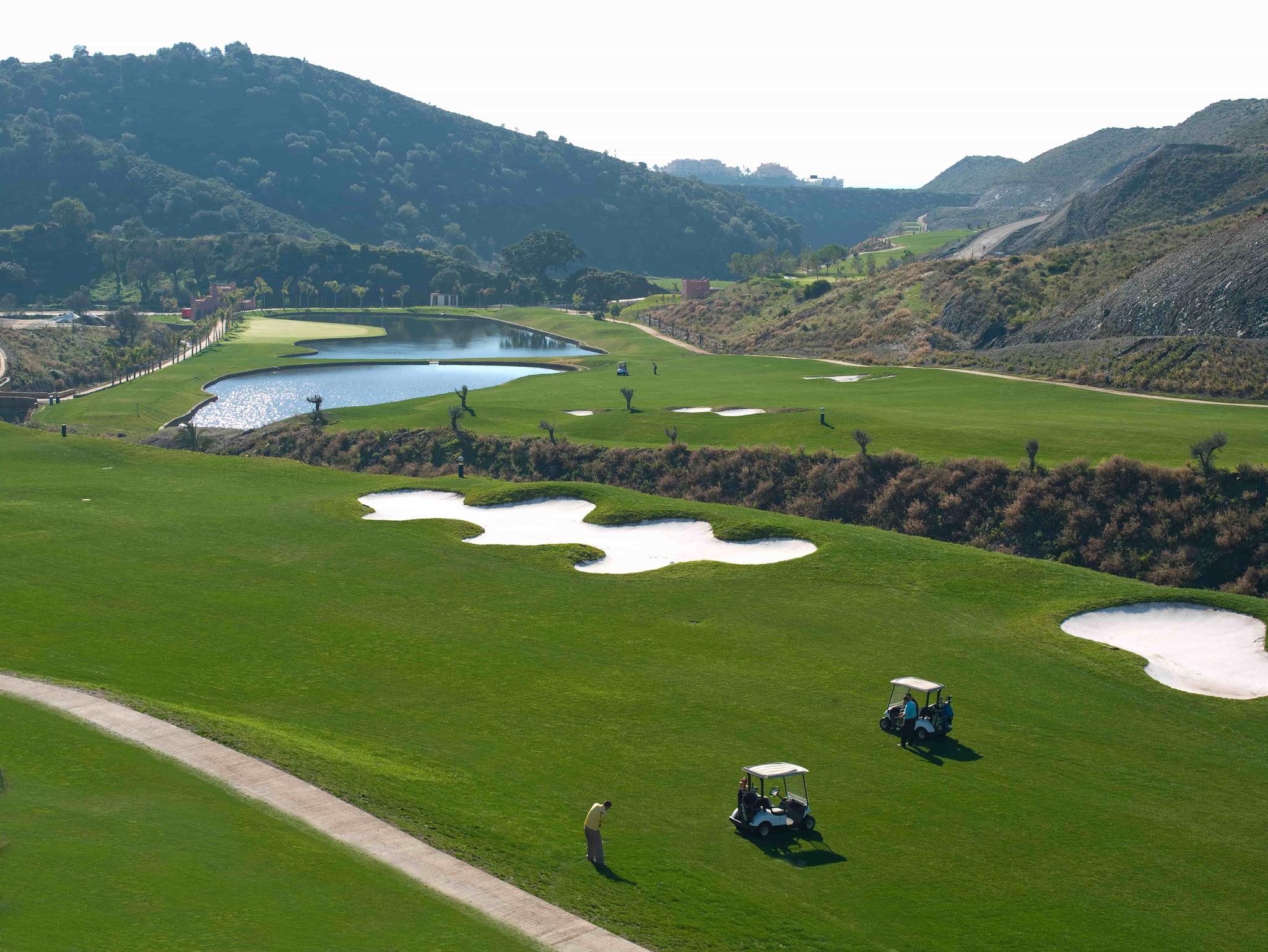 Overhead view of a well maintained fairway nestled with sand bunkers