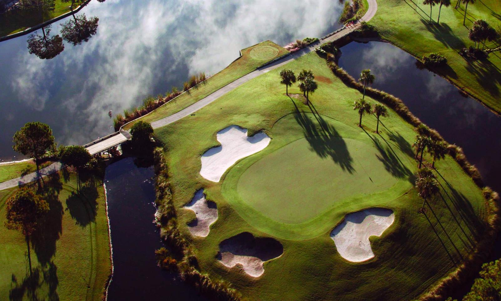 Overhead view of an island green surrounded by sand bunkers in the US