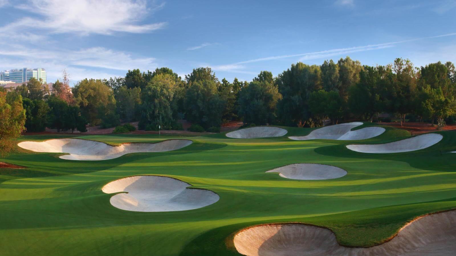 A smooth green surrounded by sand bunkers in Dubai