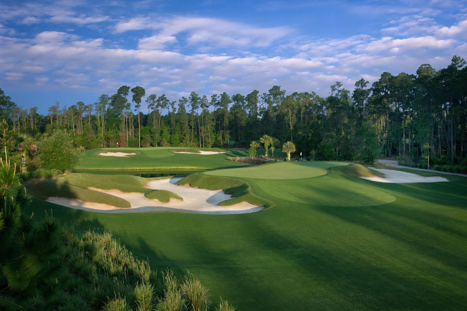 A well maintained fairway nestled with sand bunkers