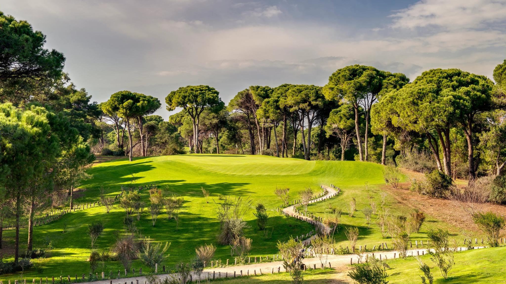 A well maintained fairway lined with trees in Turkey