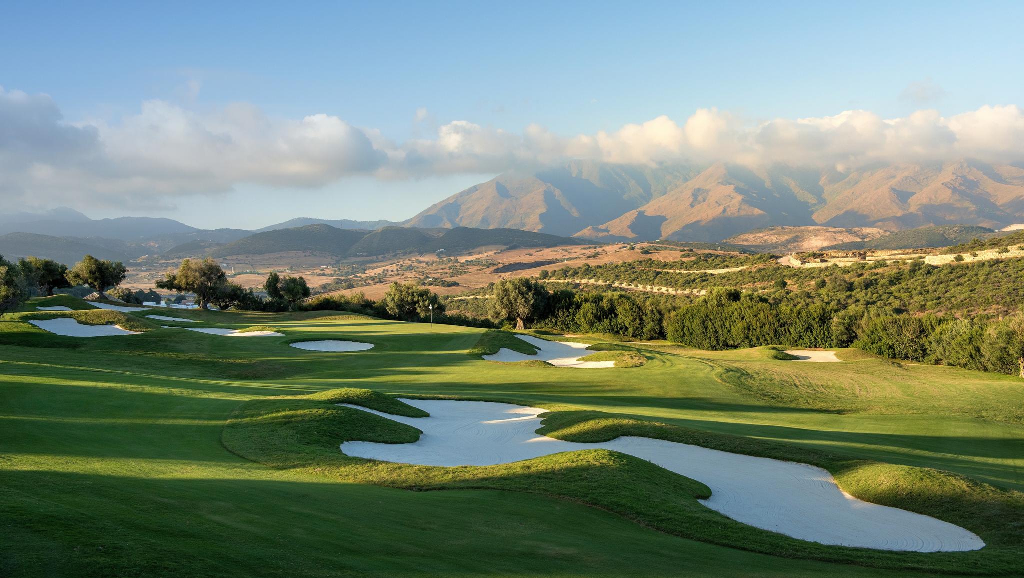 A well maintained fairway nestled with sand bunkers