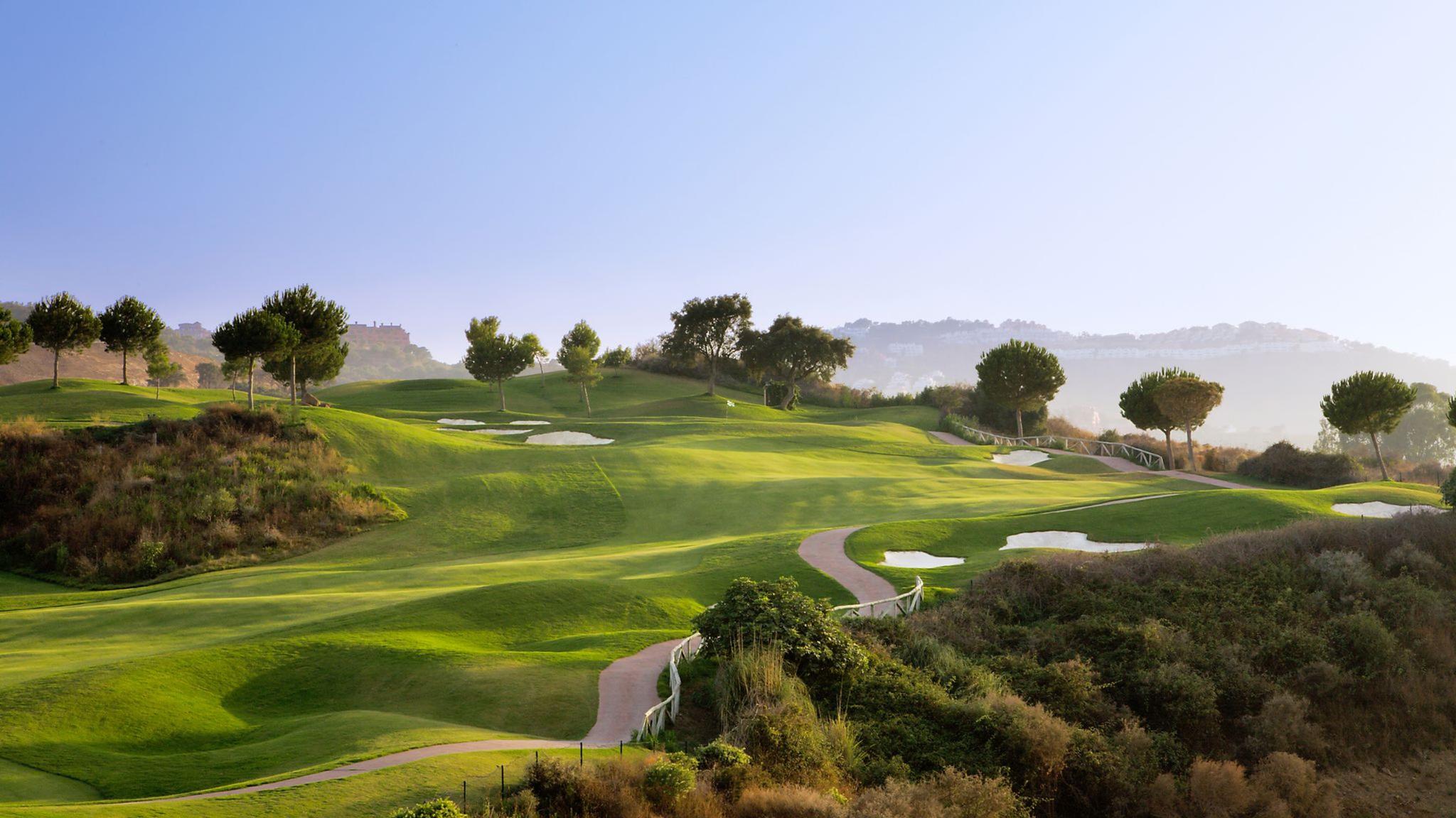 A well maintained fairway nestled with rolling dunes and sand bunkers
