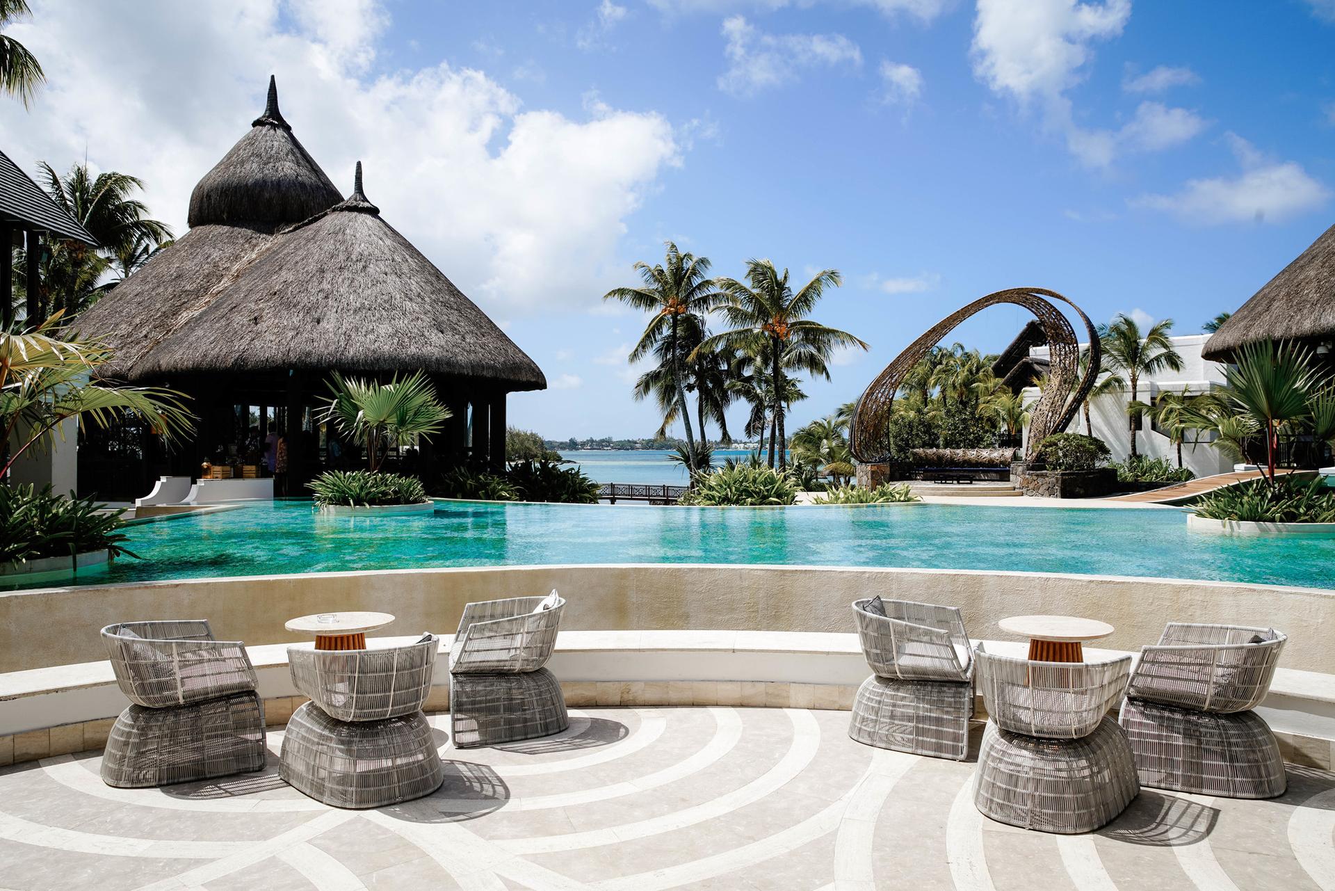 Outdoor swimming pool with poolside dining at the Shangri La Touessrok