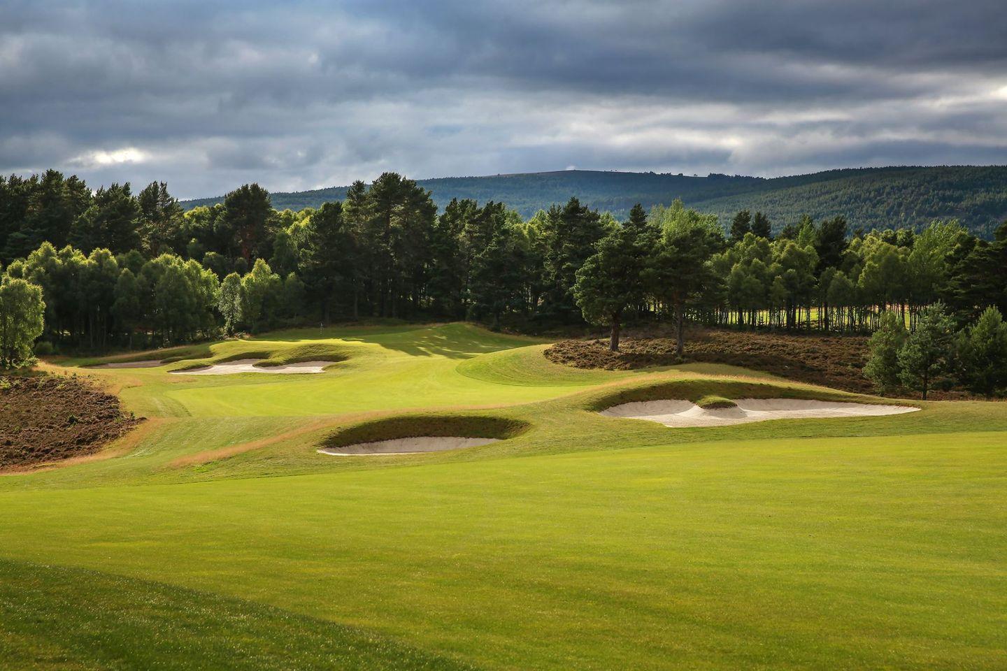 A well maintained fairway nestled with sand bunkers