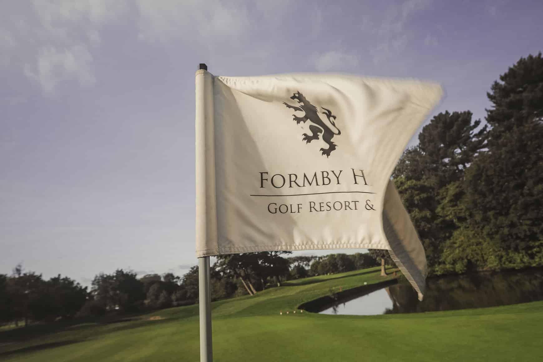 Flagstick at the golf club with the Formby Hall Golf Resort & Spa logo