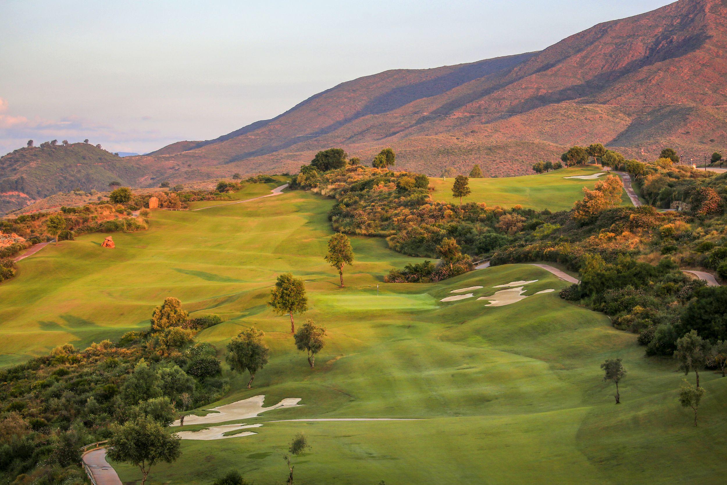 A well maintained fairway with mountain views in the distance