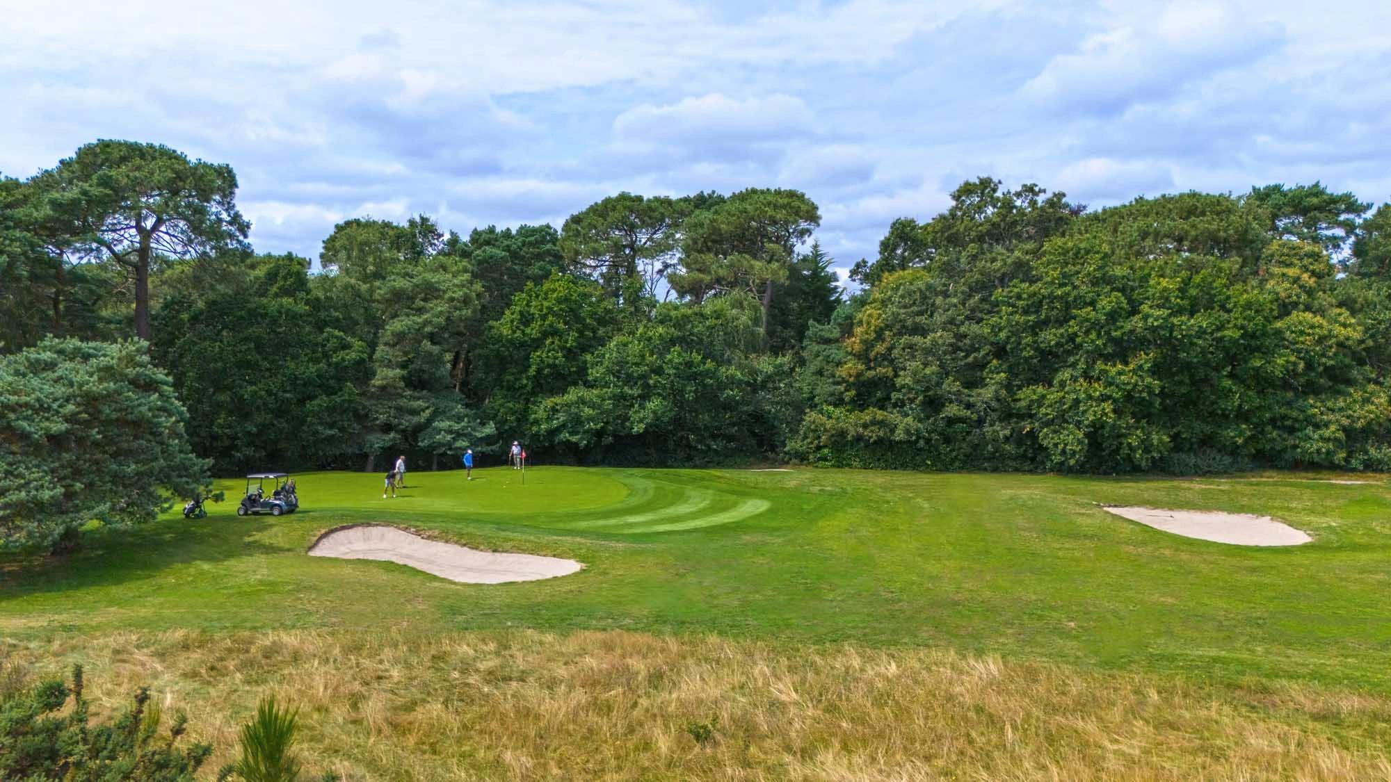 A well maintained fairway nestled with sand bunkers