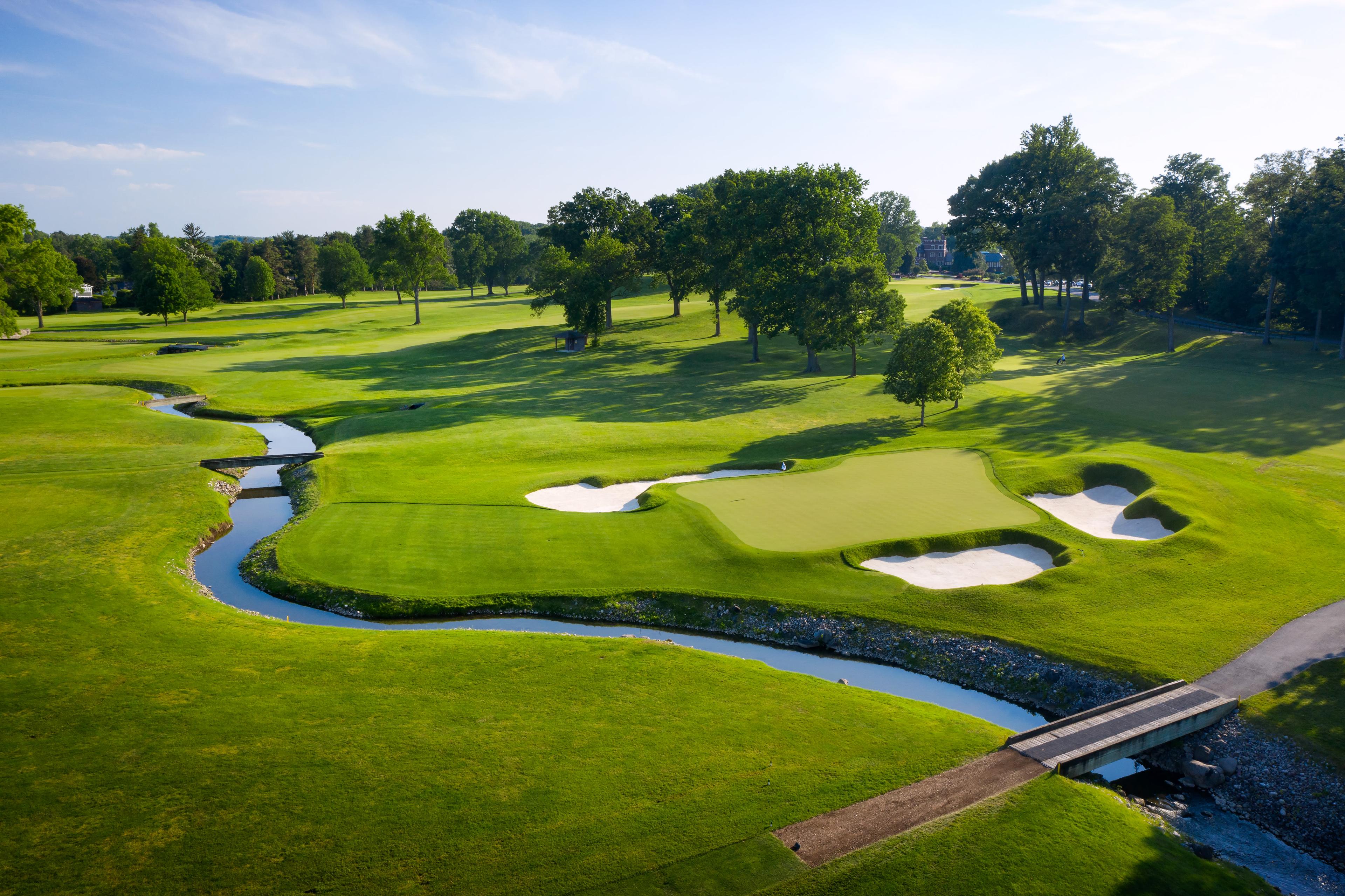 A well maintained fairway leading to a smooth green surrounded by sand bunkers