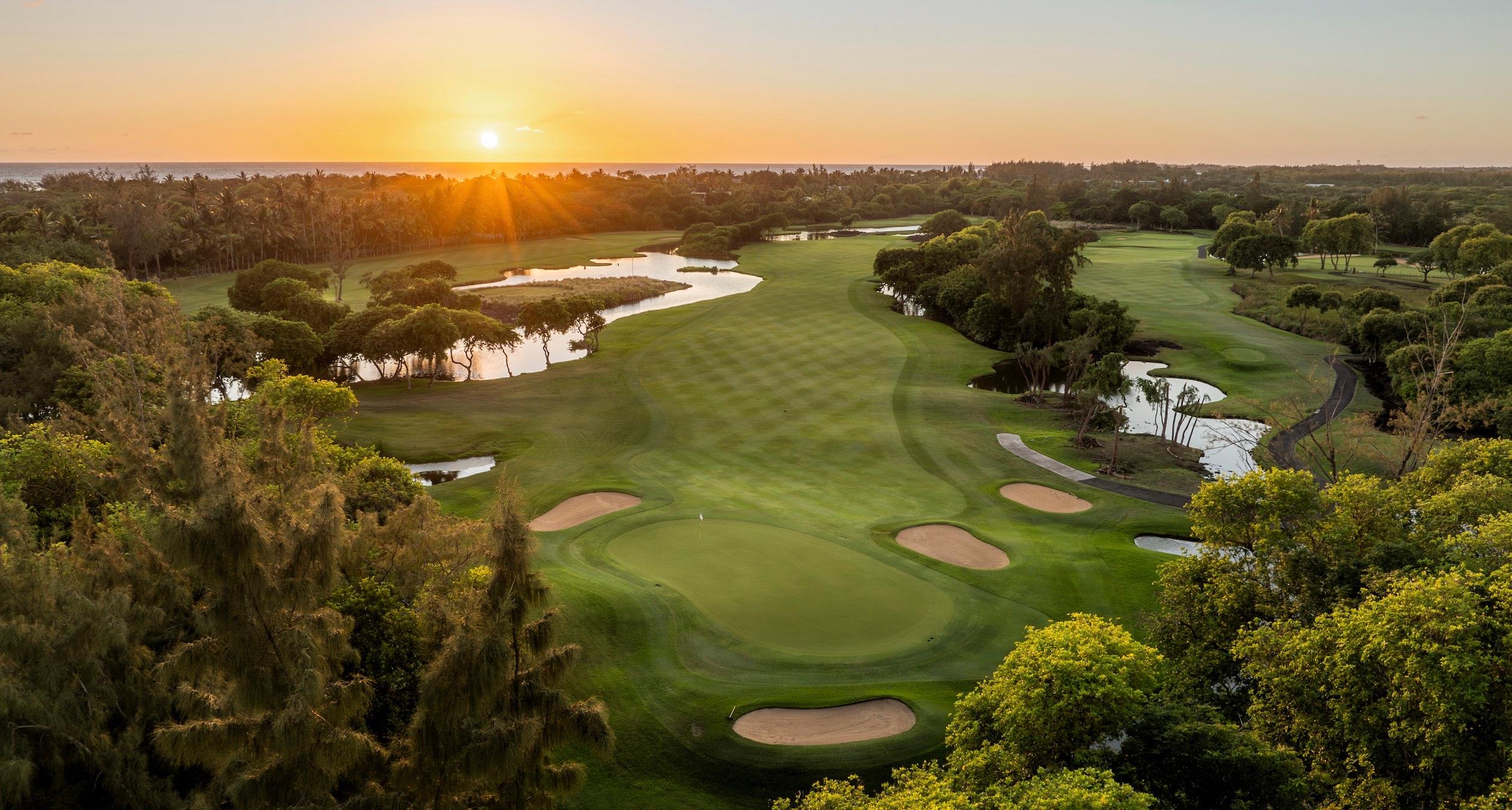 A well maintained fairway leading to a smooth green surrounded by sand bunkers