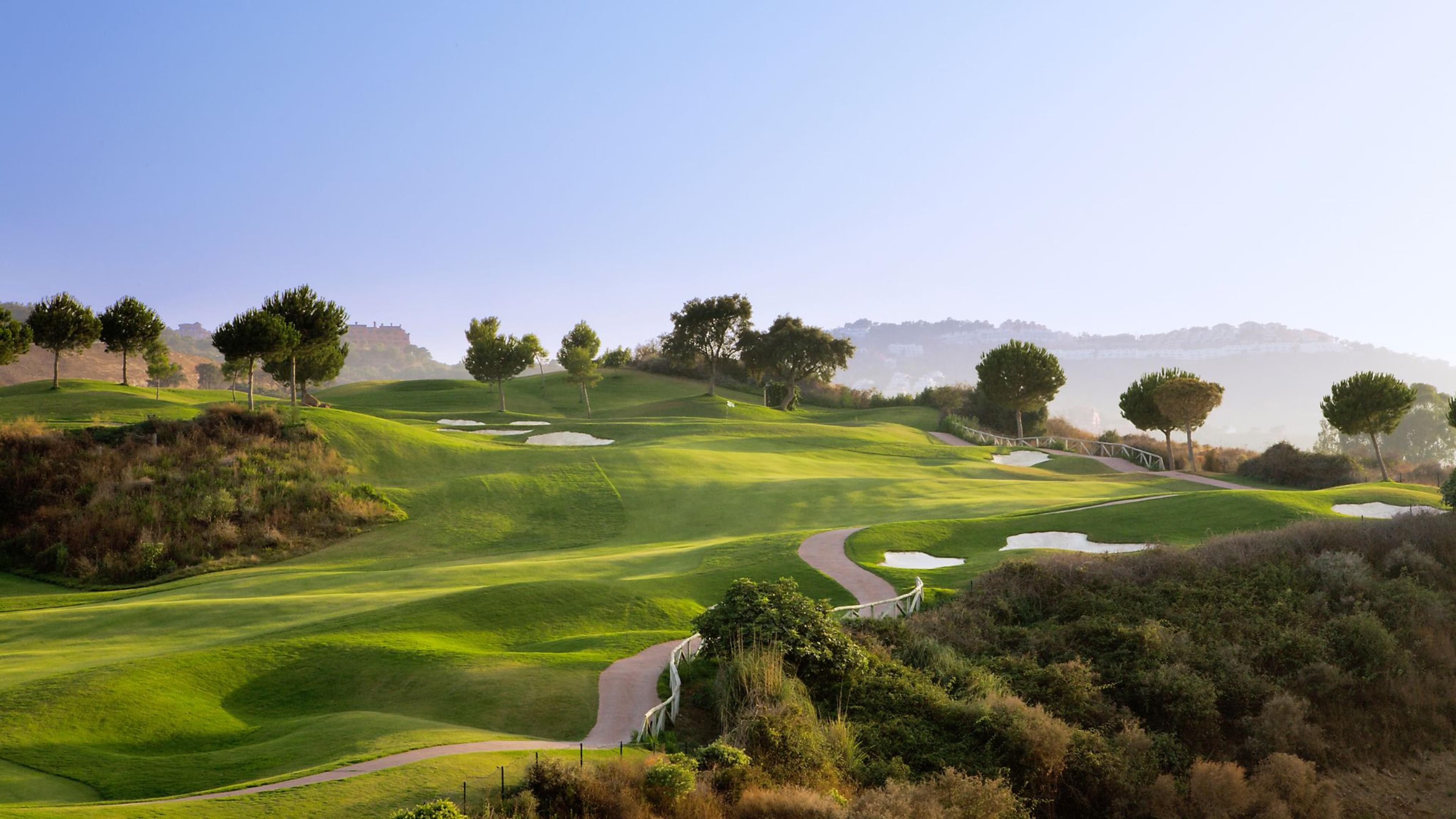 A well maintained fairway nestled with rolling dunes and sand bunkers