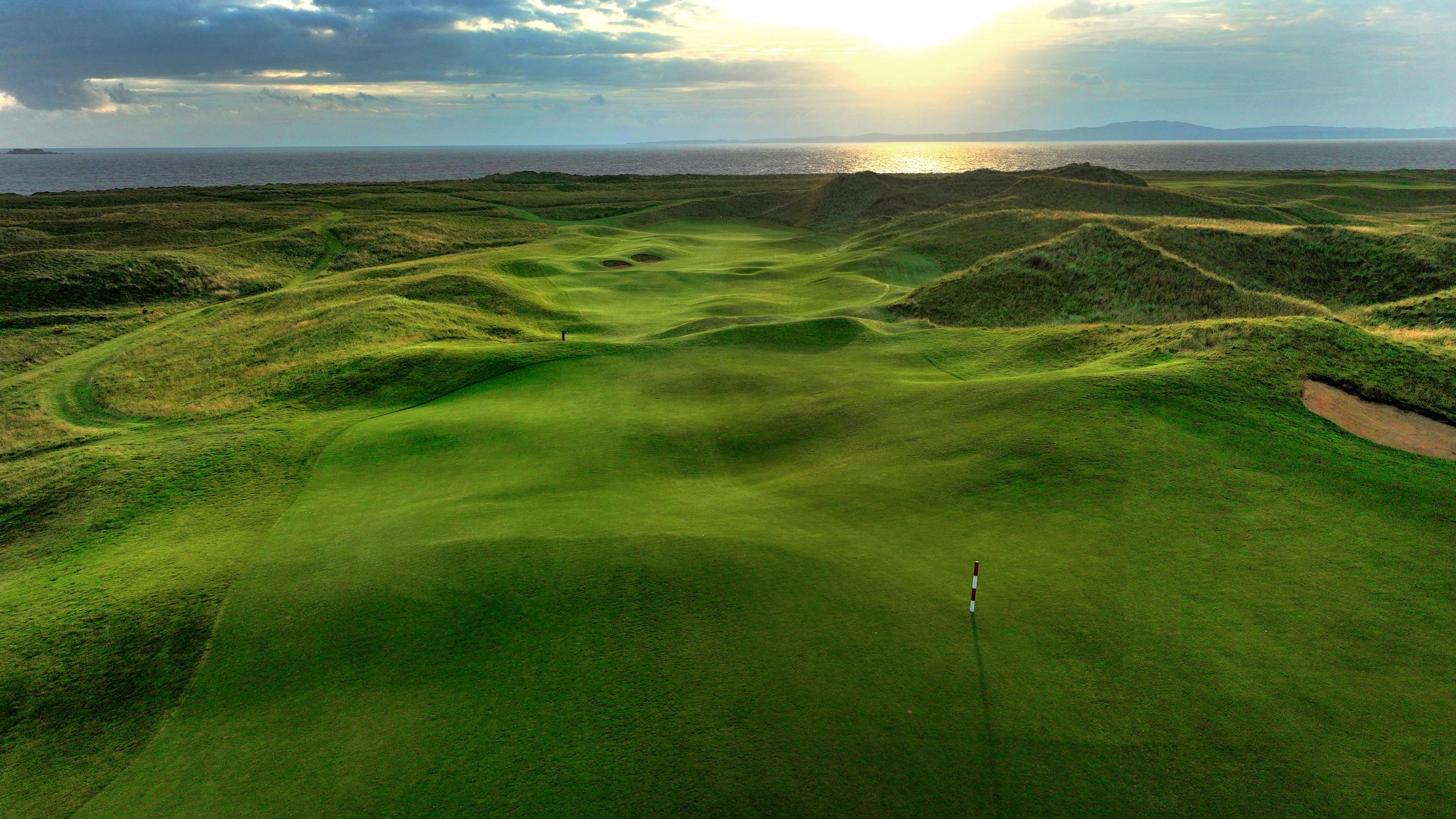 A well maintained fairway with rolling dunes leading to a smooth green