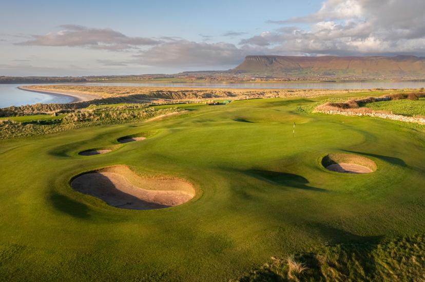 An elevated green surrounded by sand bunkers at Castle Dargan Golf Hotel