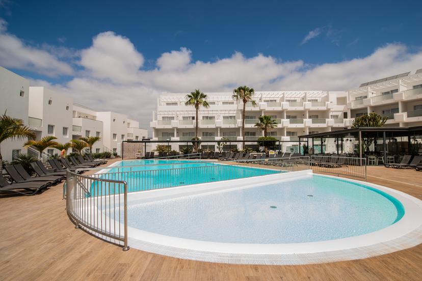 Panoramic view of an outdoor swimming pool at Aequora Lanzarote Suites