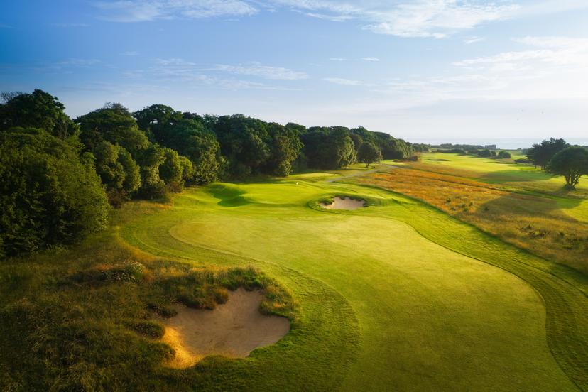 A well maintained fairway nestled with sand bunkers at Royal St George's Golf Club